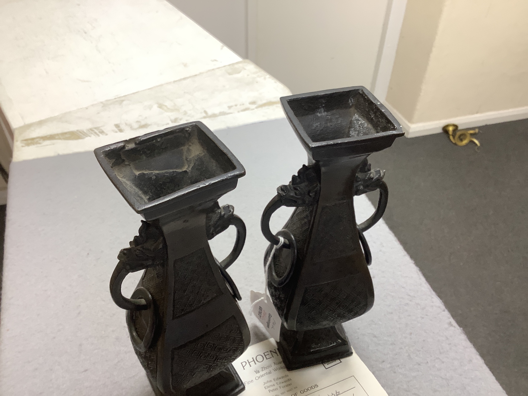 A pair of Chinese archaistic bronze two handled altar vases, Ming dynasty, 23cm high
